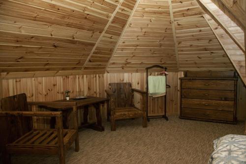a room with wooden walls and ceilings with wooden furniture at Polyanskiy Zamok in Polyana