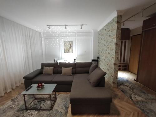a living room with a couch and a table at Decebal Premium Confort in Craiova