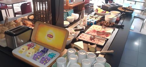 a buffet with meat and other foods on a table at Campanile Annecy - Cran Gevrier in Annecy