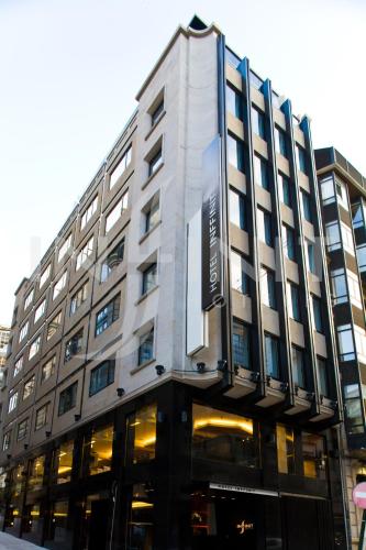a building with a sign on the front of it at Hotel Inffinit in Vigo