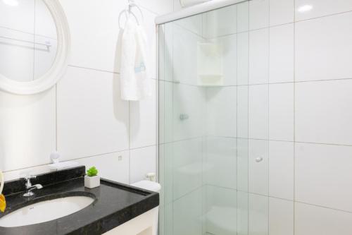 a bathroom with a shower and a sink at Praia Residence in Porto De Galinhas
