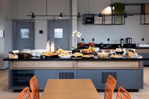 a table with food on a counter in a kitchen at ibis Botucatu in Botucatu