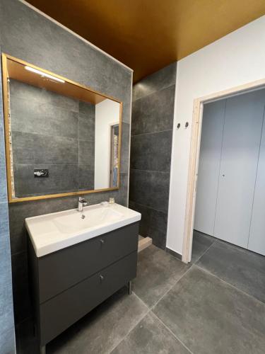 a bathroom with a sink and a mirror at Al Piano Terra in Ancona