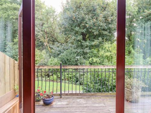 an open balcony with a view of a garden at Taw River View in Okehampton