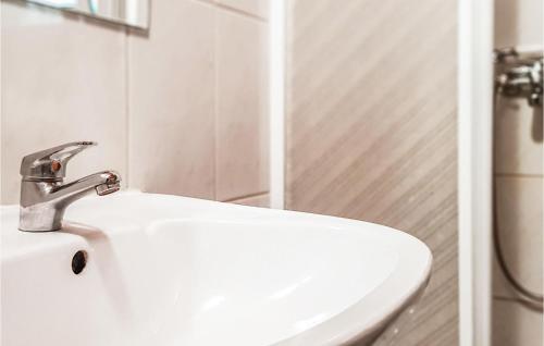 a bathroom sink with a faucet on top of it at Holiday Home Barczewo Kaplityny Vii in Barczewo