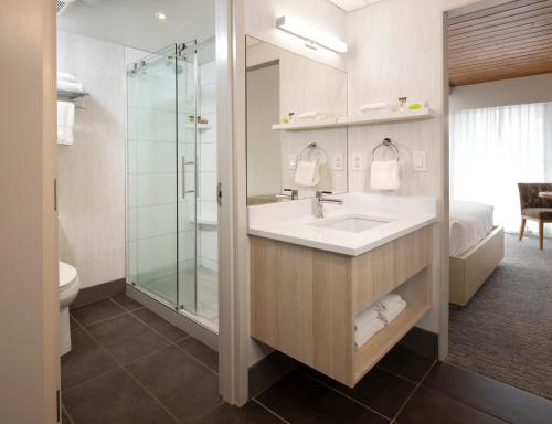 a bathroom with a sink and a shower at Banff Aspen Lodge in Banff