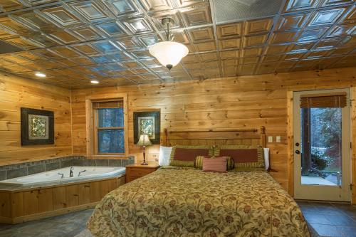 a bedroom with a bed and a bath tub at McCormack's Mill in Pigeon Forge