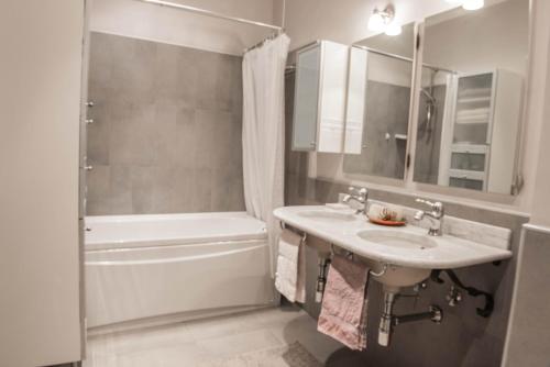 a bathroom with a sink and a tub and a shower at Narni Charm in Narni