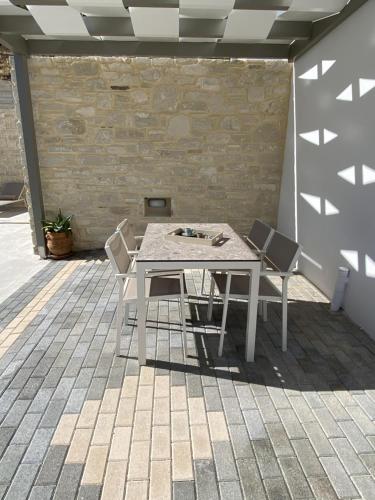 a white table and chairs on a patio at Matala Prime Villas in Matala