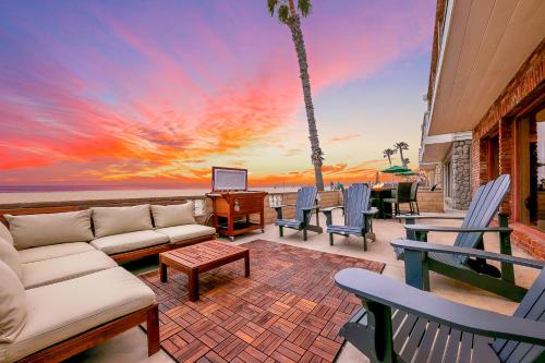 a living room with a couch and chairs and the ocean at Newport Beach Front View I in Newport Beach