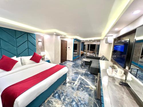 a bedroom with a large bed and a living room at Petra Sella Hotel in Wadi Musa