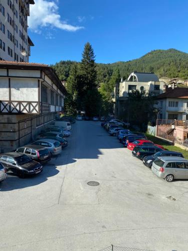 a bunch of cars parked in a parking lot at Апартамент за гости in Devin