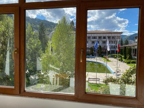a window with a view of a building at Апартамент за гости in Devin