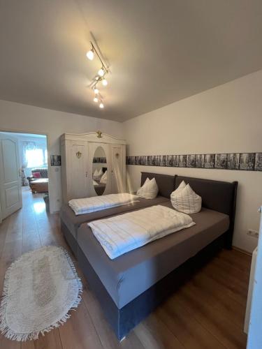 a bedroom with a large bed with a couch at Die grüne Mitte in Pullenreuth