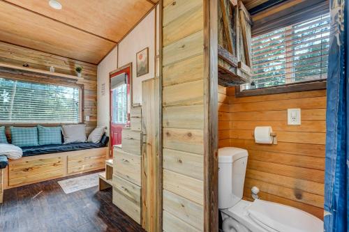 a bathroom with a tub and a toilet and a bed at NEW Lovable Mountain Tiny Home near Cripple Creek in Cripple Creek