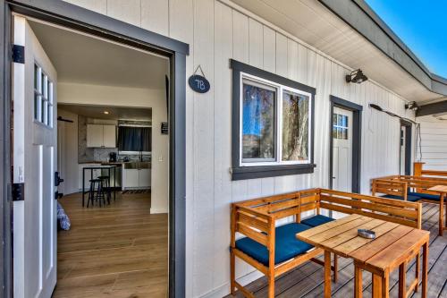 a porch with a wooden bench and a table at The Historic West Walker Motel in Walker