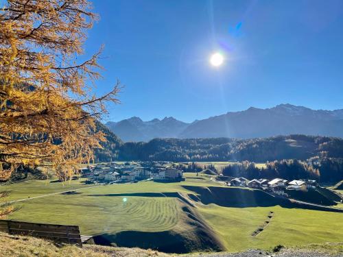 a view of a golf course with the moon overhead at Ferienhaus Knor in Umhausen