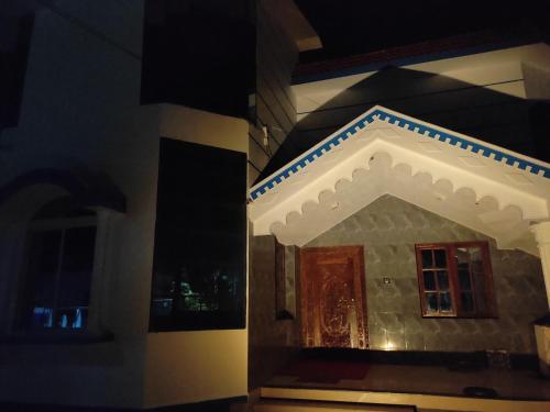 a building with a door and a window at night at Gruham Malpe Homestay Udupi in Malpe
