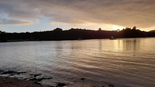 a large body of water with boats in it at Marina Vista Cabin in Tutukaka