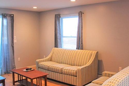 a living room with a couch and a table at Cherry Valley Retreat in Gilford