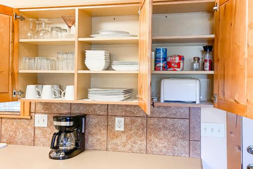 a kitchen cabinets with plates and dishes in it at Beautiful Branson in Branson West