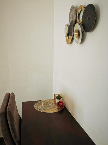 a dining room with a table and some hats on the wall at L'Address in Cotonou
