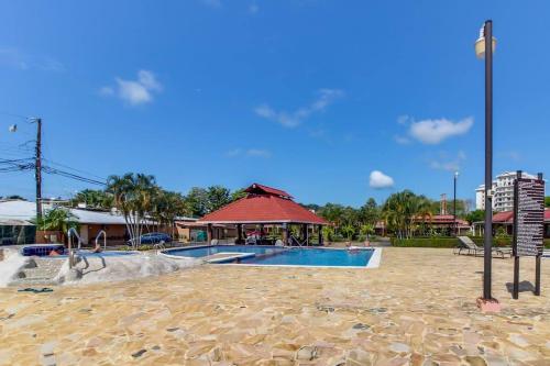 a resort with a swimming pool and a pavilion at Villa Paraíso Mango 4, Steps from the Beach & Free WIFI in Jacó