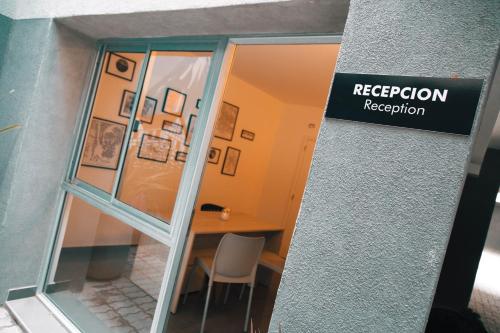 a room with a table and a sign that reads reception reception at 356 Apartments - in Mendoza