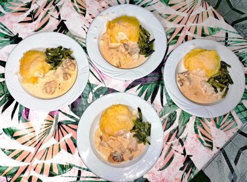 four white plates of food on a table at Voinescu House - Natural Living & Eating in Şimon