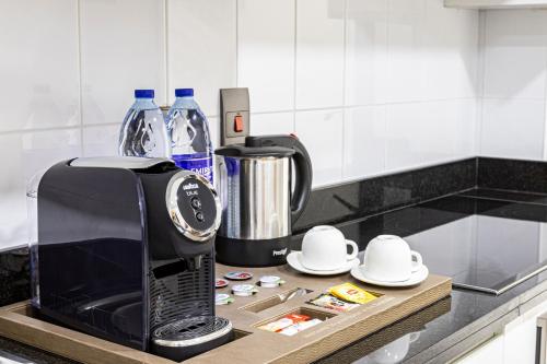 a kitchen counter with a coffee maker and a toaster at Golden Sands Suites in Dubai