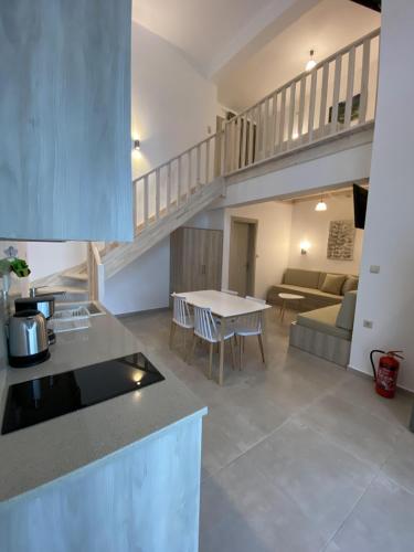 a kitchen and living room with a couch and a table at Matala Prime Villas in Matala