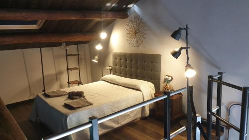 a bedroom with a bed and lights on the wall at "O Cabazo de Reinante" in Barreiros