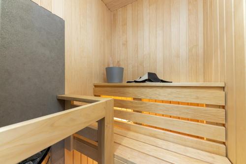 a sauna with wood paneled walls and a wooden bench at Kipperi Kodumajutus in Lihula