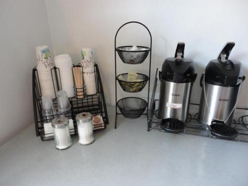 a shelf with coffee makers and other items at South Hill Motor Inn in Red Deer