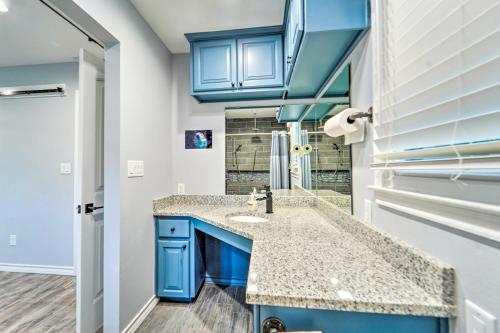 a bathroom with a sink and blue cabinets at Lovely Lubbock Home with Furnished Patio and Yard in Lubbock
