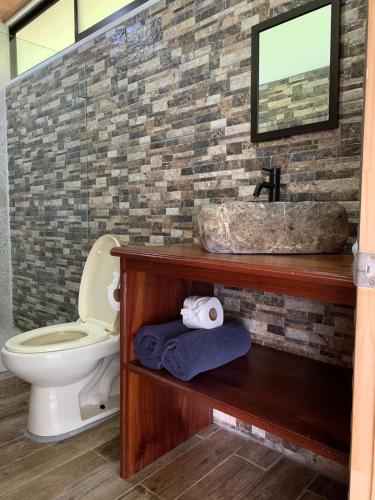 a bathroom with a sink and a toilet at Villas In Sueño Private Jungle Hotel in Manuel Antonio