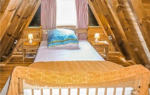 a bedroom with a bed in a room with wooden walls at Awesome Home In Stezyca With 3 Bedrooms And Wifi in Stężyca