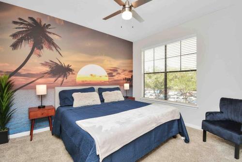 a bedroom with a blue bed and a palm tree mural at Island Paradise -2Bedroom /2Bath/NRG/MedCenter/Galleria in Houston