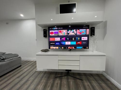 a living room with a flat screen tv on a wall at Penthouse Style Luxury 2 Bedroom House has Hot-Tub, extra fees apply in Birmingham