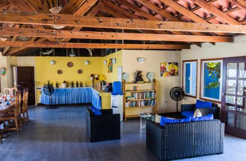 a living room with blue chairs and a table at Blue Marlin Beach Resort in Dangriga