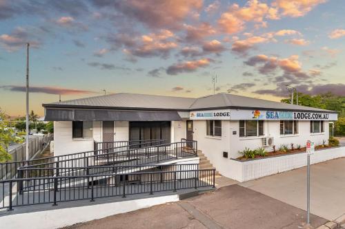 a building with a fence in front of it at Seaside Lodge Hostel Townsville- right next to coles, 2 mins walk to strand & CBD- Passport required in Townsville
