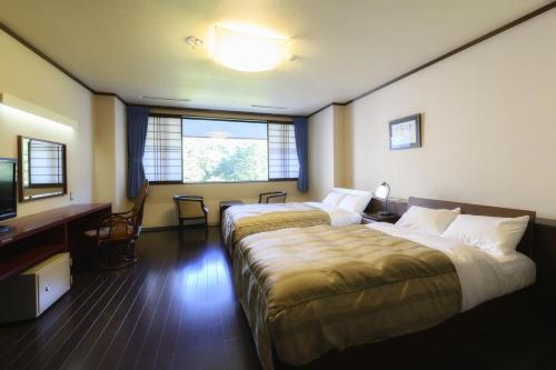 Postel nebo postele na pokoji v ubytování Takamiya Hotel Bonari no Mori