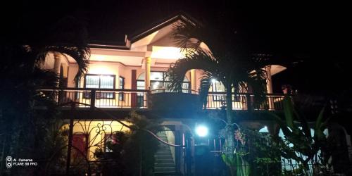 a house with a light in front of it at night at Riverside at Aninuan Accommodation and Food in Puerto Galera