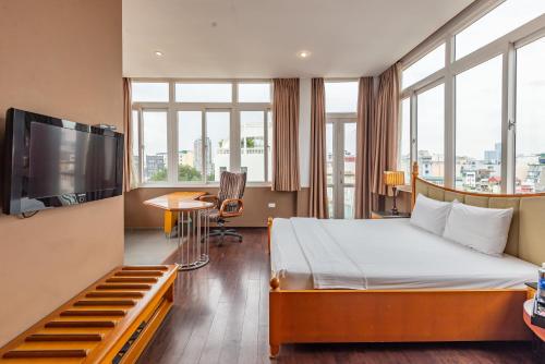 a hotel room with a bed and a flat screen tv at Hanoi Golden Sunshine Villa Hotel and Travel in Hanoi