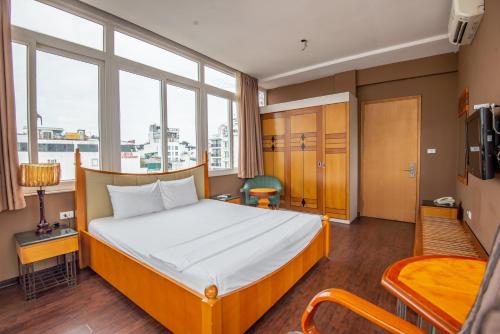a bedroom with a bed and a large window at Hanoi Golden Sunshine Villa Hotel and Travel in Hanoi