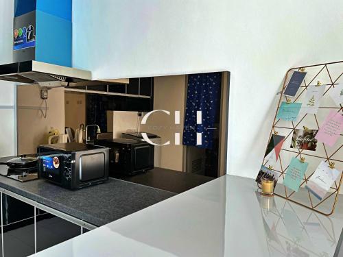 a kitchen with a counter top with a microwave at Kuching Tabuan Tranquility Apartment TT3 Soho C11 in Kuching