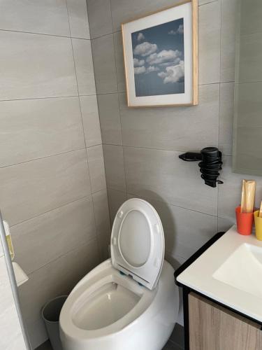 a bathroom with a toilet with the lid up at Eli House in Toucheng