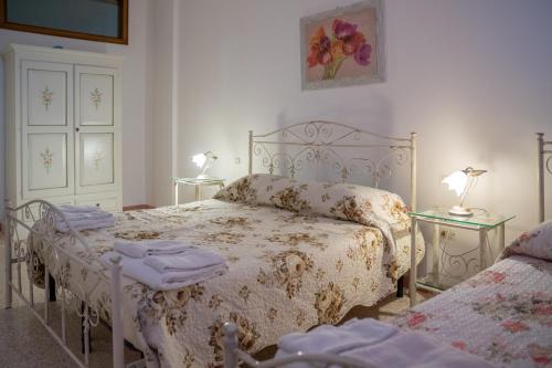 a bedroom with a bed and two tables at CASA DE ANDRE' in Montesano Salentino