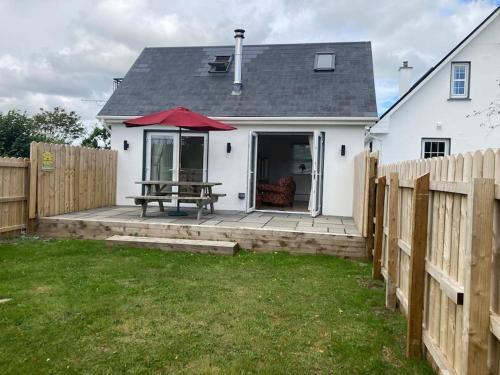 a backyard with a picnic table and a fence at Burren 1 Bed Detached Guesthouse in Galway