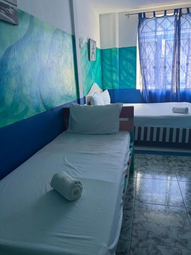 a bedroom with a bed with a pillow on it at Eden Villa in Belle Mare